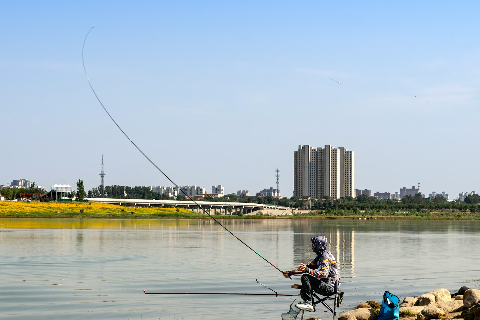 Angler casting a custom fishing rod beside the water